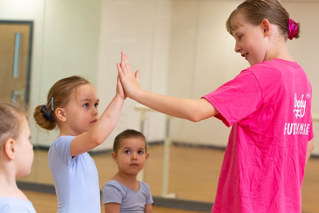 Future Dance Teacher giving a high five to a younger dancer at En Pointe Cardiff