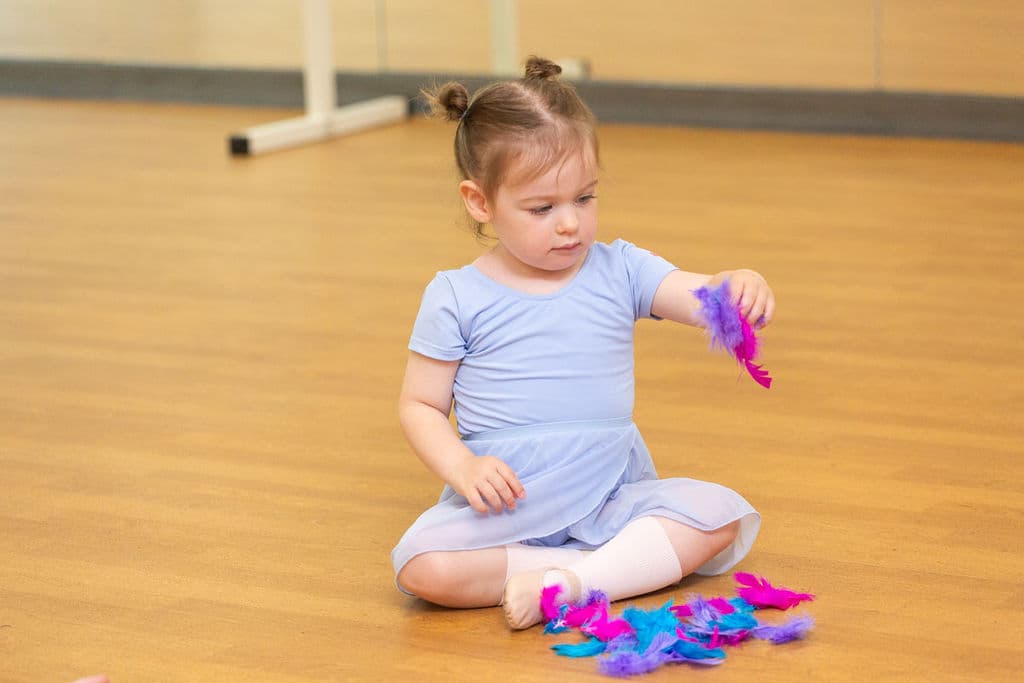 Pre-school ballet student exploring feathers at En Pointe Cardiff