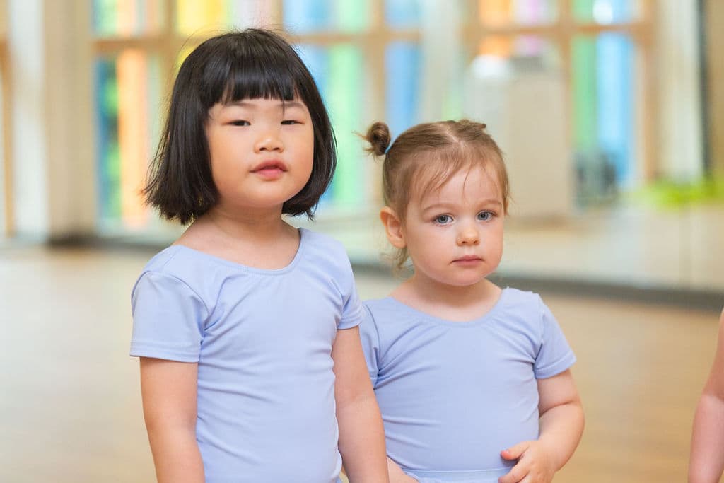Two Tiny Ballet friends standing together in class at En Pointe Cardiff