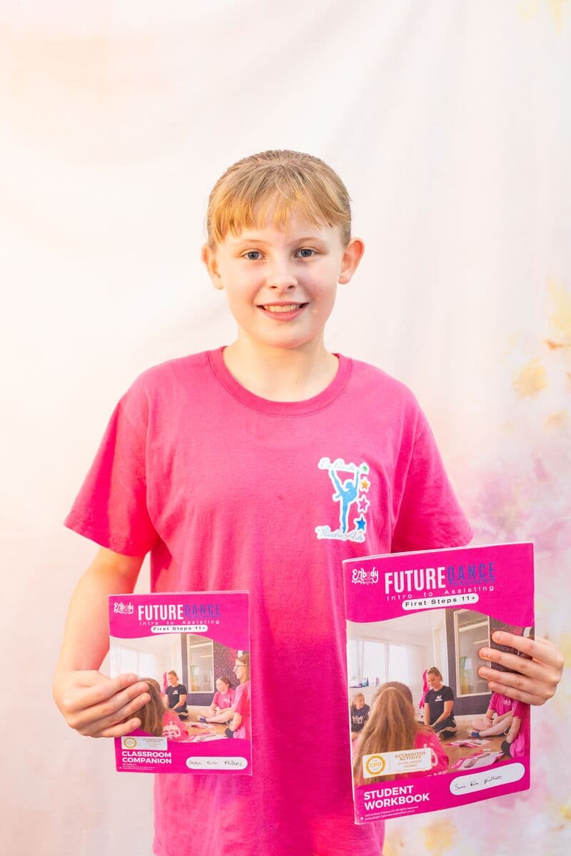 Smiling Future Dance Teacher holding course books at En Pointe Theatre Arts Cardiff